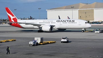 (FILES) In this file photo a Boeing 787-9 Dreamliner from Qantas Air Lines is seen on the tarmac of LAX Los Angeles airport on May 11, 2019. - Boeing will consolidate manufacturing of the 787 Dreamliner plane to one plant in the US, ending production of the wide-body jet in Washington state, the company announced on October 1, 2020. The move follows earlier announcements by Boeing that it would slash production of the jets to six per month in 2021 from 14 due to weak demand for airline travel because of the coronavirus. (Photo by Daniel SLIM / AFP)