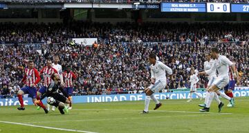 Jan Oblak makes a key save on Raphaël Varane.