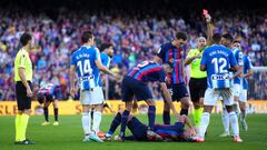 BARCELONA, SPAIN - DECEMBER 31: Vinicius Souza of RCD Espanyol receives a red card from Referee Antonio Mateu Lahoz after fouling Robert Lewandowski of FC Barcelona, who lies on the floor, during the LaLiga Santander match between FC Barcelona and RCD Espanyol at Spotify Camp Nou on December 31, 2022 in Barcelona, Spain. (Photo by Alex Caparros/Getty Images)