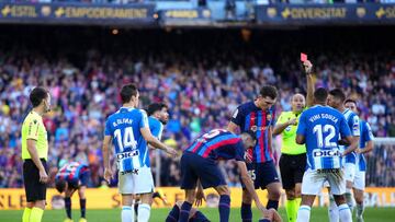 BARCELONA, SPAIN - DECEMBER 31: Vinicius Souza of RCD Espanyol receives a red card from Referee Antonio Mateu Lahoz after fouling Robert Lewandowski of FC Barcelona, who lies on the floor, during the LaLiga Santander match between FC Barcelona and RCD Espanyol at Spotify Camp Nou on December 31, 2022 in Barcelona, Spain. (Photo by Alex Caparros/Getty Images)