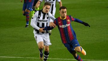 Levante&#039;s Spanish forward Jorge de Frutos (L) challenges Barcelona&#039;s US defender Sergino Dest  during the Spanish league football match between FC Barcelona and Levante UD at the Camp Nou stadium in Barcelona on December 13, 2020. (Photo by LLUI