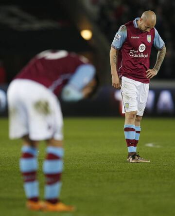 An all too familiar sight this season as Aston Villa's Alan Hutton and teammates look dejected mid-game.