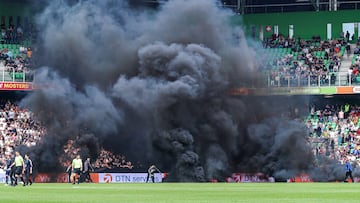 The game had been playing for six minutes when several local fans took to the field with flares and smoke canisters. Their intention was to stop the game...