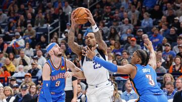 Dallas Mavericks forward P.J. Washington (25) drives between Oklahoma City Thunder guard Alex Caruso (9) and forward Dillon Jones (3) during the second quarter at Paycom Center.