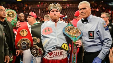 Mexican boxer Saul "Canelo" Alvarez poses with his belts and crown after defeating Kazakh boxer Gennady Golovkin to retain his undisputed super-middleweight crown at T-Mobile Arena in Las Vegas, Nevada, September 17, 2022. (Photo by Frederic J. BROWN / AFP)