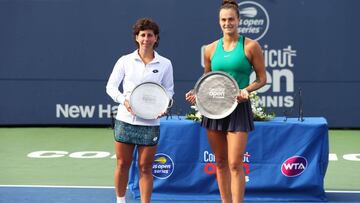 NEW HAVEN, CT - AUGUST 25: Carla Suarez Navarro of Spain, right, stands with her Finalist trophy and Aryna Sabalenka of Belarus with her Champions trophy after the Singles Final during Day 6 of the Connecticut Open at Connecticut Tennis Center at Yale on 