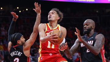 ATLANTA, GEORGIA - APRIL 22: Trae Young #11 of the Atlanta Hawks goes up for a layup against Gabe Vincent #2 and Dewayne Dedmon #21 of the Miami Heat during second half in Game Three of the Eastern Conference First Round at State Farm Arena on April 22, 2022 in Atlanta, Georgia. NOTE TO USER: User expressly acknowledges and agrees that, by downloading and or using this photograph, User is consenting to the terms and conditions of the Getty Images License Agreement.   Kevin C. Cox/Getty Images/AFP
 == FOR NEWSPAPERS, INTERNET, TELCOS &amp; TELEVISION USE ONLY ==