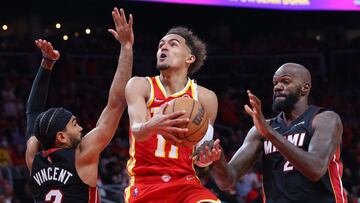 ATLANTA, GEORGIA - APRIL 22: Trae Young #11 of the Atlanta Hawks goes up for a layup against Gabe Vincent #2 and Dewayne Dedmon #21 of the Miami Heat during second half in Game Three of the Eastern Conference First Round at State Farm Arena on April 22, 2022 in Atlanta, Georgia. NOTE TO USER: User expressly acknowledges and agrees that, by downloading and or using this photograph, User is consenting to the terms and conditions of the Getty Images License Agreement. Kevin C. Cox/Getty Images/AFP
== FOR NEWSPAPERS, INTERNET, TELCOS & TELEVISION USE ONLY ==