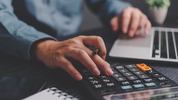 Businessman using calculator bookkeeping payroll and budget tax. Business document finance accounting investment