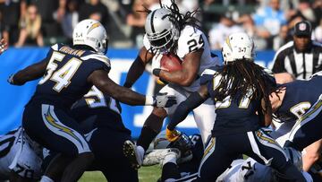 Dec 31, 2017; Carson, CA, USA; Oakland Raiders running back Marshawn Lynch (24) runs the ball against Los Angeles Chargers outside linebacker Melvin Ingram (54) and strong safety Jahleel Addae (37) during the first half at StubHub Center. Mandatory Credit: Richard Mackson-USA TODAY Sports