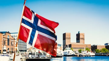 Norwegian flag in front of the city hall building in Oslo, Norway capital city during a sunny summer day.