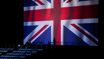 A security guard stands beside a large Union flag ahead of the Reform UK Party's rally at the NEC in Birmingham, Britain, June 30, 2024. REUTERS/Hollie Adams