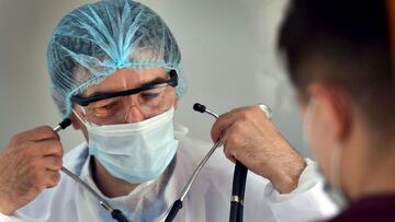 A doctor examines a patient inside a trolleybus equipped with a vaccination station in central Chisinau on July 12, 2021, amidst the ongoing coronavirus (Covid-19) pandemic. - The mobile vaccination point drives through the streets with an ambulance, transporting jabs and a medical team to different districts of the city of more than 650,000.
One of its main goals is to provide easier access to vaccines for older people and those with limited mobility. (Photo by Sergei GAPON / AFP)