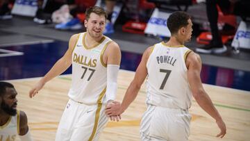 Jan 1, 2021; Dallas, Texas, USA; Dallas Mavericks guard Luka Doncic (77) and center Dwight Powell (7) celebrate during the second quarter against the Miami Heat at the American Airlines Center. Mandatory Credit: Jerome Miron-USA TODAY Sports