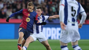 Barcelona's Spanish midfielder #16 Fermin Lopez and Real Sociedad's Spanish forward #40 Arkaitz Mariezkurrena Etxezarreta fight for the ball during the Spanish league football match between FC Barcelona and Real Sociedad at Estadi Olimpic Lluis Companys in Barcelona on March 2, 2025. (Photo by LLUIS GENE / AFP)