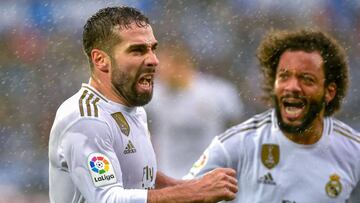 Real Madrid&#039;s Spanish defender Daniel Carvajal (L) celebrates after scoring a goal during the Spanish league football match between Deportivo Alaves and Real Madrid CF at the Mendizorroza stadium in Vitoria on November 30, 2019. (Photo by ANDER GILLE