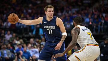 Nov 20, 2019; Dallas, TX, USA; Dallas Mavericks forward Luka Doncic (77) does a no look pass as Golden State Warriors forward Eric Paschall (7) defends during the first quarter at the American Airlines Center. Mandatory Credit: Jerome Miron-USA TODAY Sports