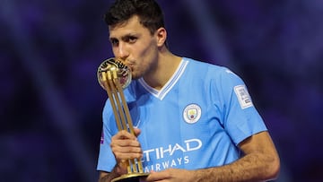 Manchester City's Spanish midfielder #16 Rodrigo Hernandez kisses his golden ball trophy during presentation at the end of the FIFA Club World Cup 2023 football final match against Brazil's Fluminense at King Abdullah Sports City Stadium in Jeddah on December 22, 2023. (Photo by Giuseppe CACACE / AFP)