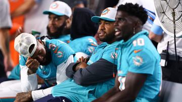 MIAMI GARDENS, FLORIDA - AUGUST 17: Odell Beckham Jr. #3, Tua Tagovailoa #1 and Tyreek Hill #10 of the Miami Dolphins react on the bench against the Washington Commanders during the fourth quarter of a preseason game at Hard Rock Stadium on August 17, 2024 in Miami Gardens, Florida. Megan Briggs/Getty Images/AFP (Photo by Megan Briggs / GETTY IMAGES NORTH AMERICA / Getty Images via AFP)