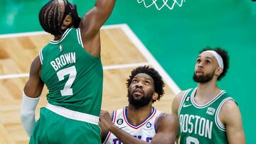 Boston Celtics guard Jaylen Brown (L) dunks over Philadelphia 76ers center Joel Embiid (C) of Cameroon as Celtics guard Derrick White (R) looks on during the second half of game 2 of the NBA Eastern Conference semifinals series between the Philadelphia 76ers and the Boston Celtics at TD Garden in Boston, Massachusetts, USA, 03 May 2023.