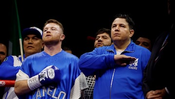 Boxing - Saul 'Canelo' Alvarez vs William Scull - Undisputed Super Middleweight Championship - ANB Arena, Riyadh, Saudi Arabia - May 3, 2025 Saul 'Canelo' Alvarez and his coach Eddy Reynoso during the national anthems ahead of his super middleweight fight against William Scull REUTERS/Hamad I Mohammed