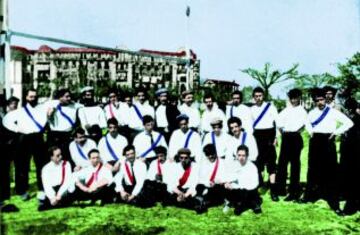 Real Madrid in the halcyon days of 1902. A white shirt with a purple stripe and black shorts.The stripe disappeared in 1905 while the black socks were standard until 1954.