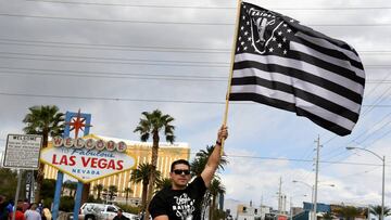 Raiders fan Matt Gutierrez of Nevada waves a Raiders flag in front of the Welcome to Fabulous Las Vegas sign after National Football League owners voted 31-1 to approve the team&#039;s application to relocate to Las Vegas during their annual meeting on March 27, 2017 in Las Vegas, Nevada.