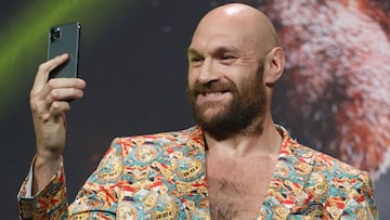 WBC heavyweight champion Tyson Fury records himself on a cell phone during a news conference at MGM Grand Garden Arena on October 6, 2021 in Las Vegas, Nevada. 