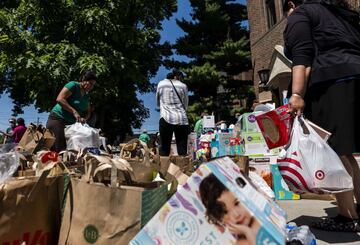 MINNEAPOLIS, MN - MAY 30: People arrange donations at Holy Trinity Lutheran Church on May 30, 2020 in Minneapolis, Minnesota. Buildings and businesses around the Twin Cities have been looted and destroyed in the fallout after the death of George Floyd while in police custody. Police Officer Derek Chauvin has been charged with third-degree murder and manslaughter in Floyd's death. Stephen Maturen/Getty Images/AFP == FOR NEWSPAPERS, INTERNET, TELCOS & TELEVISION USE ONLY ==