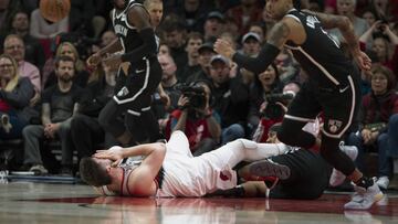 Portland Trail Blazers center Jusuf Nurkic goes down after being hit in the face as the Blazers beat the Brooklyn Nets in double-overtime, 148-144, during an NBA basketball game in Portland, Ore., Monday, March 25, 2019. Nurkic later left the game after going down again. (AP Photo/Randy L. Rasmussen)