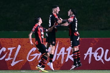 Alajuelense's Alberto Toril (C) celebrates with teammates