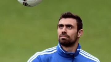 Greek defender Giannis Maniatis eyes the ball during a training session at the Municipal stadium of Legionowo on June 20, 2012. Greece will face Germany in the Euro 2012 football championchips quarter-finals. AFP PHOTO / ARIS MESSINIS