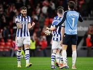 Real Sociedad's Croatian defender #16 Duje Caleta Car and Real Sociedad's Spanish goalkeeper #01 Alex Remiro celebrate at the end of the Spanish Copa del Rey (King's Cup) semi final first leg football match between Athletic Club Bilbao and Real Sociedad at San Mames Stadium in Bilbao on February 11, 2026. (Photo by ANDER GILLENEA / AFP)