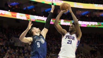 Feb 24, 2018; Philadelphia, PA, USA; Philadelphia 76ers center Joel Embiid (21) shoots against Orlando Magic center Nikola Vucevic (9) during the second quarter at Wells Fargo Center. Mandatory Credit: Bill Streicher-USA TODAY Sports