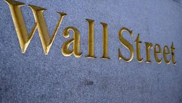 A sign reading "Wall Street" on a building near the New York Stock Exchange (NYSE) on Wall Street on July 12, 2022 in New York City. (Photo by ANGELA WEISS / AFP) (Photo by ANGELA WEISS/AFP via Getty Images)