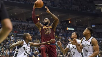 Oct 20, 2017; Milwaukee, WI, USA; Cleveland Cavaliers forward LeBron James (23) shoots the ball defended by Milwaukee Bucks forward Khris Middleton (22) and forward John Henson (31) and forward Giannis Antetokounmpo (34) in the second quarter at BMO Harris Bradley Center. Mandatory Credit: Benny Sieu-USA TODAY Sports