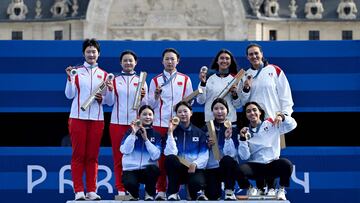 Gold medalists (C) South Korea's Jeon Hunyoung, South Korea's Lim Sihyeon and South Korea's Lim Sihyeon, silver medalists China's team (L) and Bronze medalits Mexico's team (R) pose on the podium of the archery Women's team final during the Paris 2024 Olympic Games at the Esplanade des Invalides in Paris on July 28, 2024. (Photo by Punit PARANJPE / AFP)