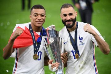 Kylian Mbappe and Karim Benzema celebrate with the trophy at the end of the Nations League final football match between Spain and France at San Siro stadium in Milan, on October 10, 2021.