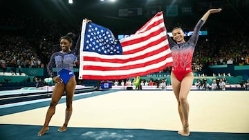US' Simone Biles (L) and US' Sunisa Lee celebrates after winning respectively the gold and bronze medal at the end of the artistic gymnastics women's all around final of the Paris 2024 Olympic Games at the Bercy Arena in Paris, on August 1, 2024. (Photo by Loic VENANCE / AFP)