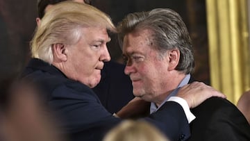 (FILES) In this file photo taken on January 22, 2017 US President Donald Trump (L) congratulates Senior Counselor to the President Stephen Bannon during the swearing-in of senior staff in the East Room of the White House in Washington, DC. - President Don