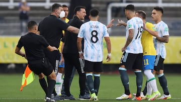 Soccer Football - World Cup - South American Qualifiers - Brazil v Argentina - Arena Corinthians, Sao Paulo, Brazil - September 5, 2021 Argentina coach Lionel Scaloni and others are seen on the pitch as play is interrupted after Brazilian health officials