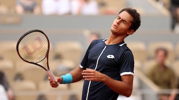 PARIS, FRANCE - MAY 22:  Juan Pablo Varillas of Peru reacts against Felix Auger-Aliassime of Canada during the Men's Singles First Round match on Day 1 of The 2022 French Open at Roland Garros in Paris, France. (Photo by Ryan Pierse/Getty Images)