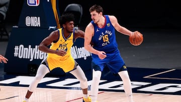 Jan 14, 2021; Denver, Colorado, USA; Denver Nuggets center Nikola Jokic (15) controls the ball as Golden State Warriors center James Wiseman (33) guards in the fourth quarter at Ball Arena. Mandatory Credit: Isaiah J. Downing-USA TODAY Sports