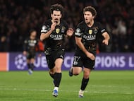 Paris Saint-Germain's Portuguese midfielder #17 Vitinha (L) celebrates with Paris Saint-Germain's Portuguese midfielder #87 Joao Neves after scoring his side's third goal during the UEFA Champions League round of 16 first leg football match between Paris Saint-Germain (PSG) and Chelsea at the Parc des Princes stadium in Paris on March 11, 2026. (Photo by FRANCK FIFE / AFP)