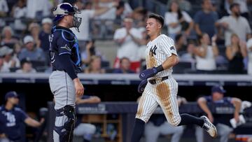Jul 29, 2025; Bronx, New York, USA; New York Yankees shortstop Anthony Volpe (11) scores a run after Tampa Bay Rays catcher Nick Fortes (40) threw the ball away when Volpe stole third base during the fourth inning at Yankee Stadium. Mandatory Credit: Brad Penner-Imagn Images