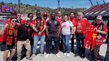 Andy Cole posa con un grupo de aficionados del Manchester United en el Snapdragon Stadium de San Diego, California.