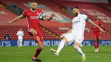LIVERPOOL, ENGLAND - APRIL 14: Nathaniel Phillips of Liverpool is closed down by Karim Benzema of Real Madrid during the UEFA Champions League Quarter Final Second Leg match between Liverpool FC and Real Madrid at Anfield on April 14, 2021 in Liverpool, E