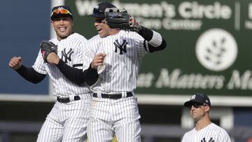 New York Yankees left fielder Giancarlo Stanton, left, and right fielder Aaron Judge, center, react as left fielder Brett Gardner looks on after they defeated the Baltimore Orioles 7-2 during an opening day baseball game at Yankee Stadium, Thursday, March 28, 2019, in New York. (AP Photo/Julio Cortez)