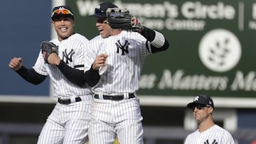 New York Yankees left fielder Giancarlo Stanton, left, and right fielder Aaron Judge, center, react as left fielder Brett Gardner looks on after they defeated the Baltimore Orioles 7-2 during an opening day baseball game at Yankee Stadium, Thursday, March 28, 2019, in New York. (AP Photo/Julio Cortez)