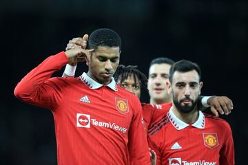 Marcus Rashford celebrates with teammates after scoring their third goal against Everton.